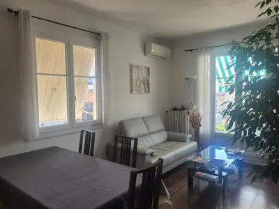 a living room with a couch and a table at Apartment nice view in Nice