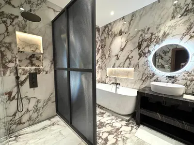a bathroom with a tub and a sink and a mirror at Duplex design - Old Town 50 m from the sea in Villefranche-sur-Mer