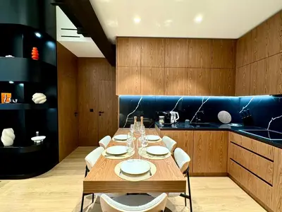 a dining room with a table and chairs and a kitchen at Duplex design - Old Town 50 m from the sea in Villefranche-sur-Mer