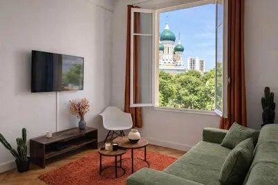 a living room with a couch and a large window at Joli appartement central, tout équipé & proche gare in Nice