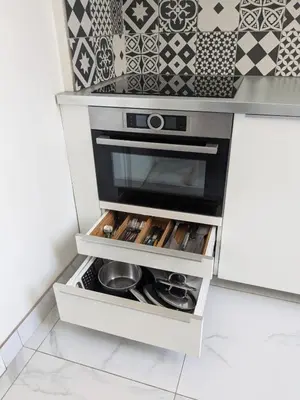 a kitchen with an open drawer with pots and pans at Joli appartement central, tout équipé & proche gare in Nice