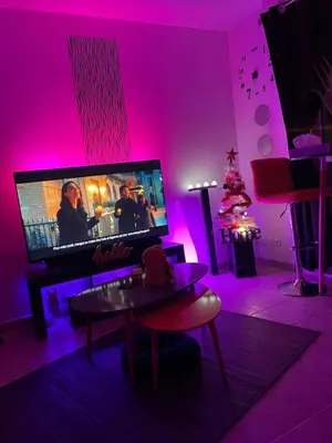 a living room with a tv and a christmas tree at Studio 27m2 en résidence standing piscine in Nice