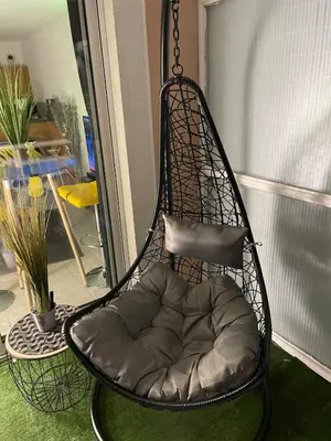 a black swing chair with a pillow in a room at Studio 27m2 en résidence standing piscine in Nice