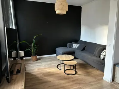 a living room with a blue couch and a table at Apartment in Nice