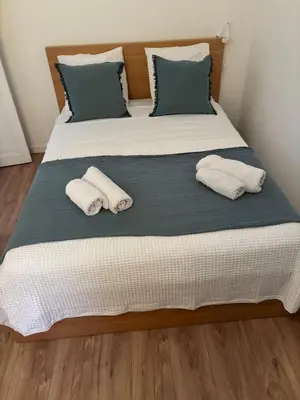 a large bed with two pillows on it at Apartment in Nice