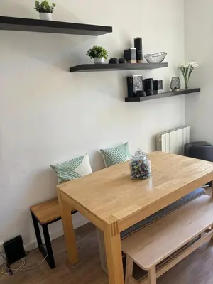 a wooden table and bench in a room at Apartment in Nice
