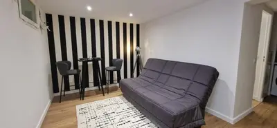 a living room with a purple couch and chairs at Charmant studio sur la Promenade des Anglais in Nice