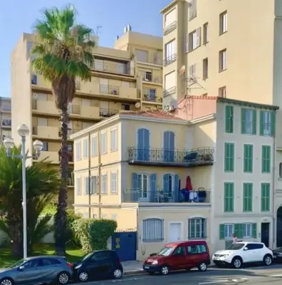 a group of cars parked in front of a building at Charmant studio sur la Promenade des Anglais in Nice