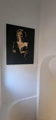 a picture of a woman on a white wall at Charmant studio sur la Promenade des Anglais in Nice