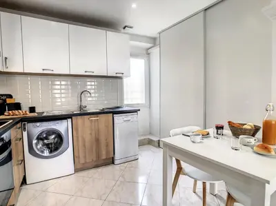 a kitchen with a washing machine and a table at Nestor&Jeeves - BELA VISTA - Central - Close sea in Nice