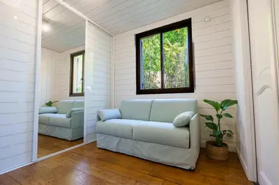 a living room with a couch and a window at Appartment - Panoramic Sea View - Swimming Pool in Villefranche-sur-Mer