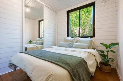 a bedroom with a large bed and a window at Appartment - Panoramic Sea View - Swimming Pool in Villefranche-sur-Mer