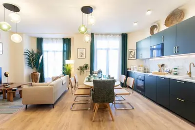 a kitchen and living room with a table and chairs at L10 Suite Clemenceau Central, next train station in Nice