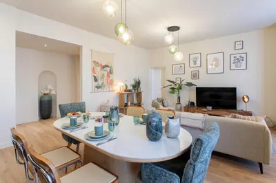 a living room with a table and chairs at L10 Suite Clemenceau Central, next train station in Nice