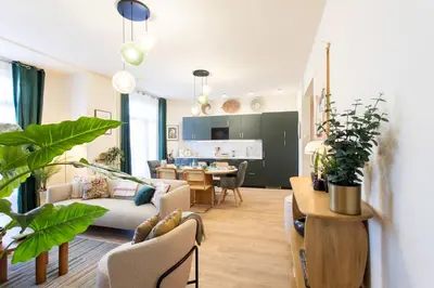a living room with a couch and a table with plants at L10 Suite Clemenceau Central, next train station in Nice