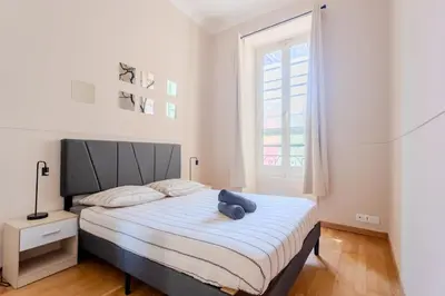a bedroom with a bed with a teddy bear on it at Nice acropolis 3 pièces proche du centre in Nice