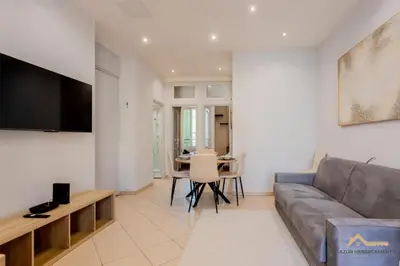 a living room with a couch and a table at Nice acropolis 3 pièces proche du centre in Nice