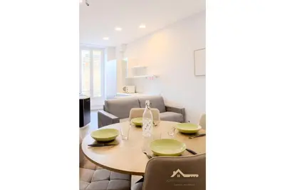 a dining room with a table and chairs at Nice Tête au carré 3 pièces proche coulée verte in Nice