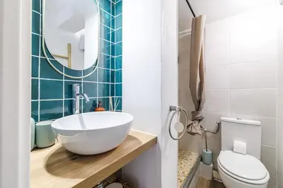 a small bedroom with a bed and a staircase at Joli Studio du Paillon in Nice