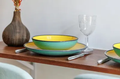 a table with three bowls and a wine glass at Joli Studio du Paillon in Nice