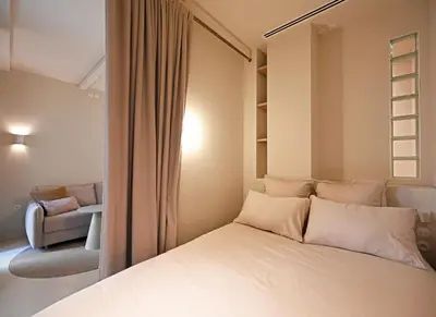 a bedroom with a bed and a chair at Appartement d architecte - wifi, AC, 3 pers in Nice