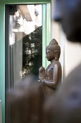 a statue of a man praying in front of a window at Appartement d architecte - wifi, AC, 3 pers in Nice