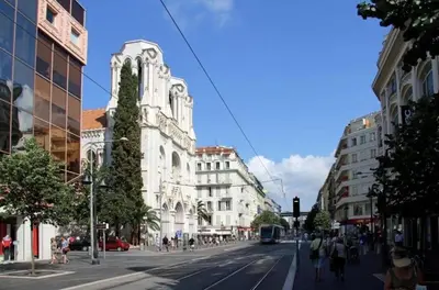 a city street with buildings and people walking down the street at Modern & Central Apartment in Nice