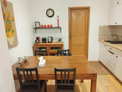 a kitchen with a wooden table and chairs at Old town Nice, near Flower Market in Nice