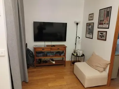 a living room with a television and a white couch at Old town Nice, near Flower Market in Nice
