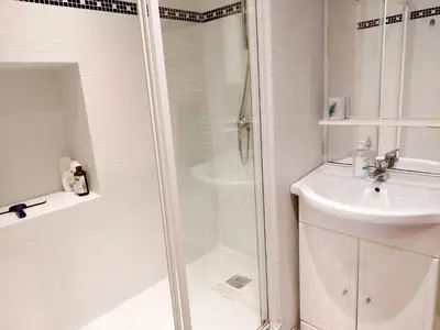 a white bathroom with a shower and a sink at Old town Nice, near Flower Market in Nice