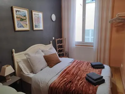 a bedroom with a bed with two towels on it at Old town Nice, near Flower Market in Nice