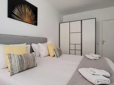 a bedroom with a large white bed with towels on it at Nestor&Jeeves - BEETHOVEN - Residential Area - Central in Nice