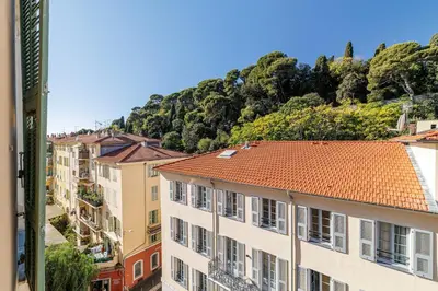 a group of buildings with a mountain in the background at Cozy and bright appartement - Port of Nice in Nice