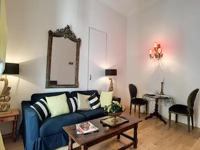 a living room with a blue couch and a table at Nestor&Jeeves - PALAIS ALICE - Central - Near Beach in Nice