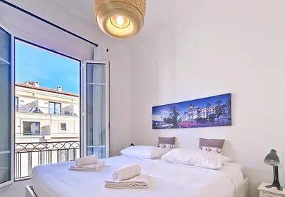 a bedroom with a large white bed with a large window at Nestor&Jeeves - SWEETHEART - Central location - Close Old Town in Nice