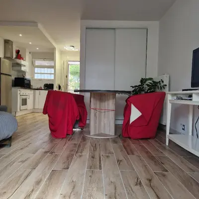 a kitchen with a table and two red chairs at F1 cap 3000 in Saint-Laurent-du-Var
