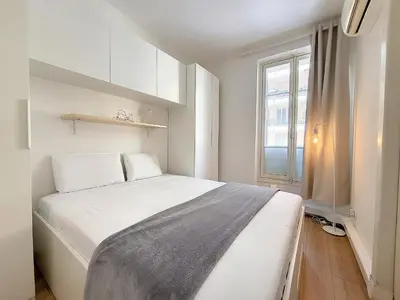 a bedroom with a white bed and a window at Nestor&Jeeves - SEA AND SUN - Central - Close sea in Nice