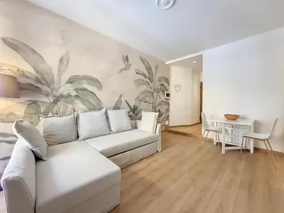 a living room with a white couch and a table at Nestor&Jeeves - SEA AND SUN - Central - Close sea in Nice
