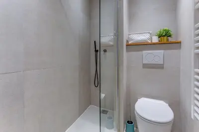a bathroom with a toilet and a glass shower at ESCAPADE AP4463 By Riviera Holiday Homes in Villefranche-sur-Mer