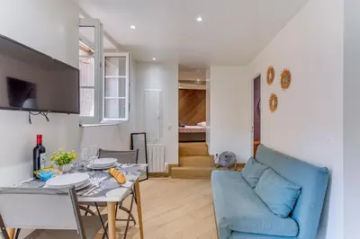 a living room with a blue couch and a table at ESCAPADE AP4463 By Riviera Holiday Homes in Villefranche-sur-Mer