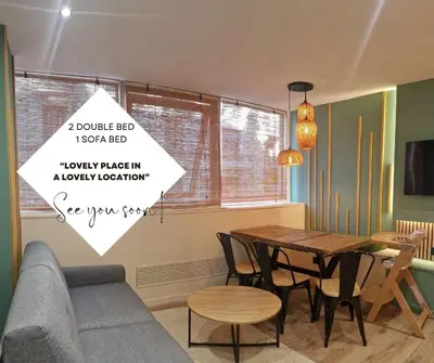 a living room with a table and a couch at PASTO DROITE Appartement Nice 6P in Nice
