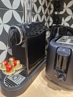 a toaster oven with some muffins on a plate at PASTO DROITE Appartement Nice 6P in Nice