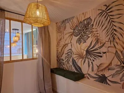 a room with a wall with a painting of plants at PASTO DROITE Appartement Nice 6P in Nice
