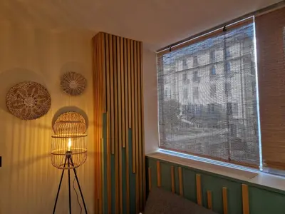 a window in a room with a lamp in front of it at PASTO GAUCHE Appartement Nice 6P in Nice