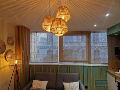 a living room with a couch and two chandeliers at PASTO GAUCHE Appartement Nice 6P in Nice