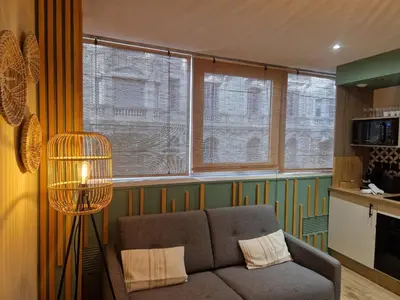 a living room with a couch and some windows at PASTO GAUCHE Appartement Nice 6P in Nice