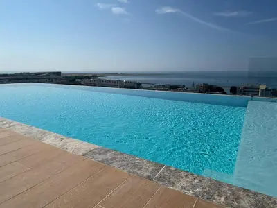 a swimming pool with a view of the ocean at Seaside Azur in Saint-Laurent-du-Var