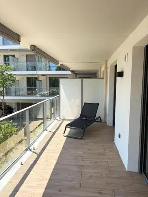 a chair sitting on the balcony of a building at Seaside Azur in Saint-Laurent-du-Var