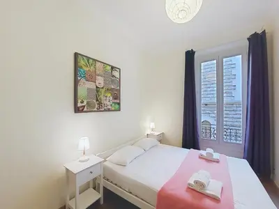 a bedroom with a white bed and a window at Nestor&Jeeves - CALIFORNIA - Central - Very close sea in Nice
