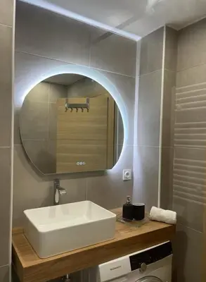 a bathroom with a white sink and a mirror at Jolie studio in Nice